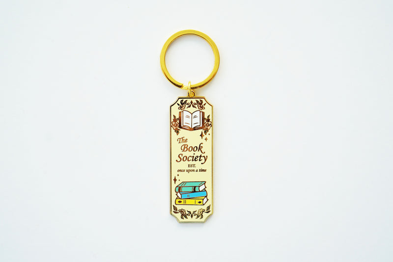 Book Society Gold Enamel Keychain, Light