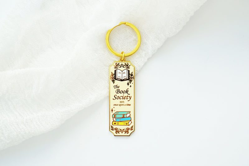 Book Society Gold Enamel Keychain, Light