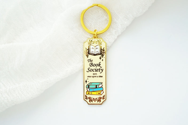 Book Society Gold Enamel Keychain, Light