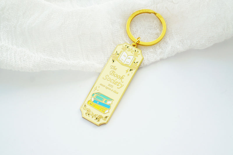 Book Society Gold Enamel Keychain, Light